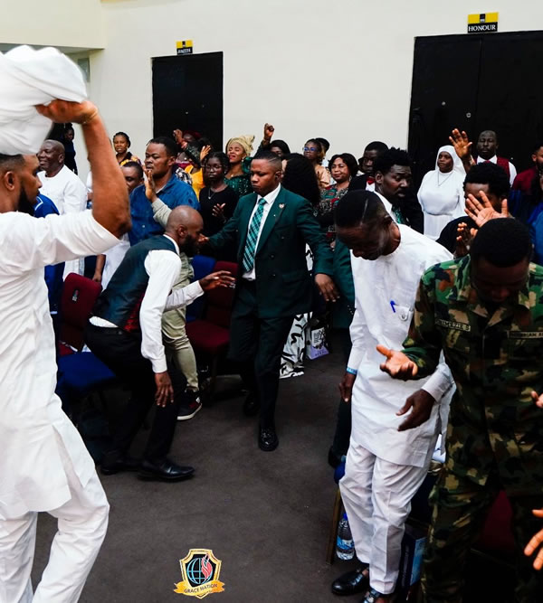 Church members praying together in fellowship gathering